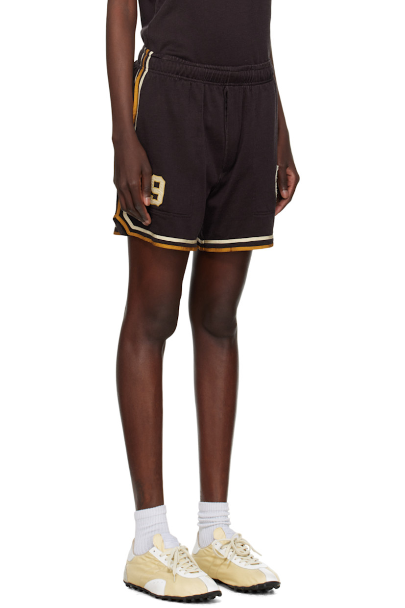 Rayon- and cotton-blend jersey shorts. 

· Concealed drawstring at elasticized waistband
· Three-pocket styling
· Graphic and text appliqués at front 
· Stripes at outseams, back, and cuffs 

This item is part of a limited run of 80.

Supplier color: Brown/Black