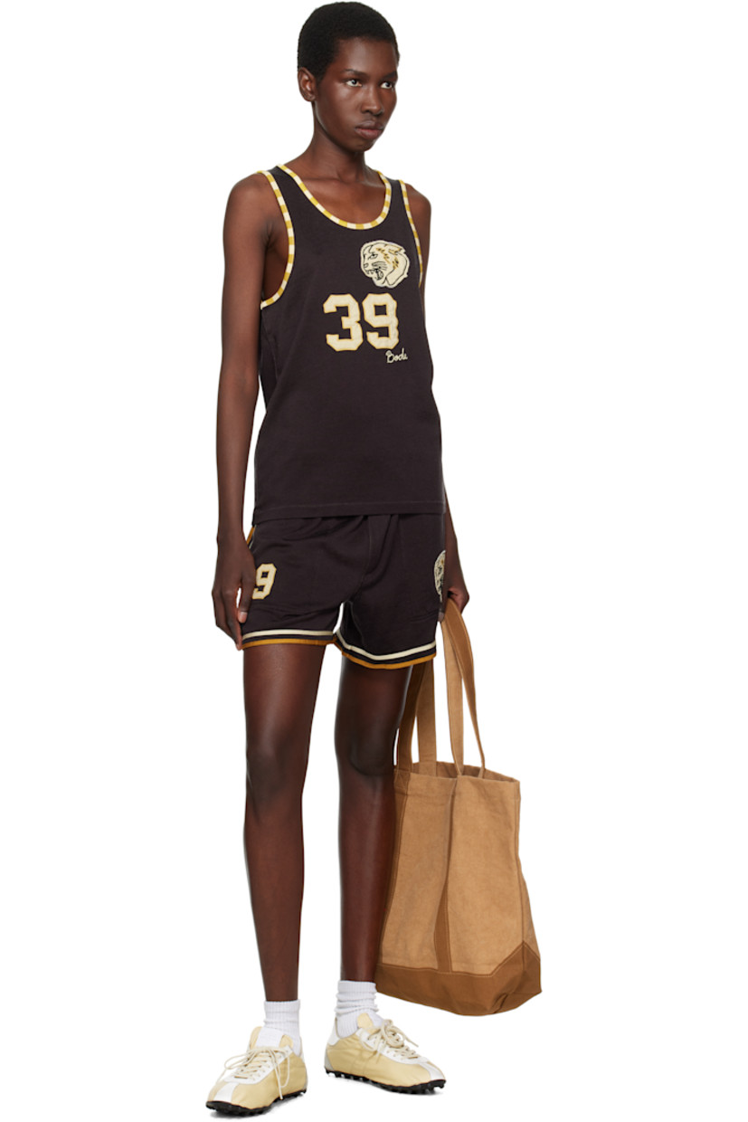 Rayon- and cotton-blend jersey shorts. 

· Concealed drawstring at elasticized waistband
· Three-pocket styling
· Graphic and text appliqués at front 
· Stripes at outseams, back, and cuffs 

This item is part of a limited run of 80.

Supplier color: Brown/Black