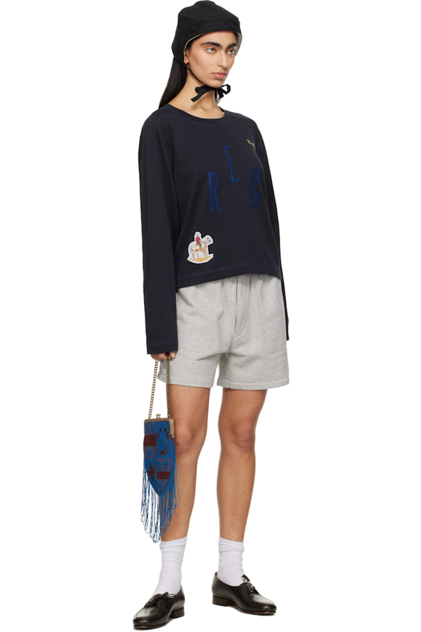 Heavyweight cotton- and lyocell-blend jersey sweatshirt.

· Rib-knit crewneck
· Logo embroidered at chest
· Felted text appliqués at front
· Graphic patch at hem
· Modified saddle shoulders
· Contrast stitching in blue

This item is part of a limited run of 90.

Supplier color: Navy