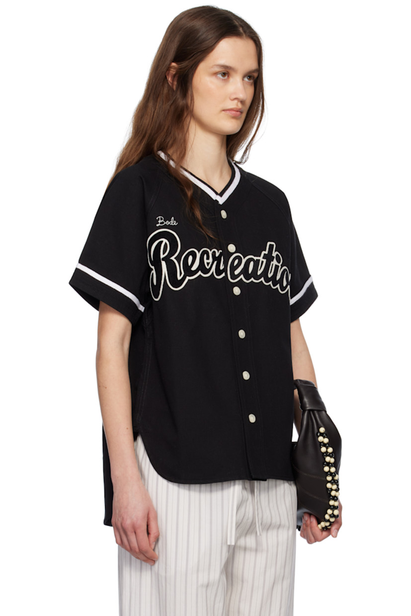 Cotton twill shirt.

· Webbing trim at V-neck and cuffs
· Button closure
· Logo embroidered at chest
· Felted text appliqué at front and back
· Shirttail hem
· Raglan sleeves

This item is part of a limited run of 136.

Supplier color: Black