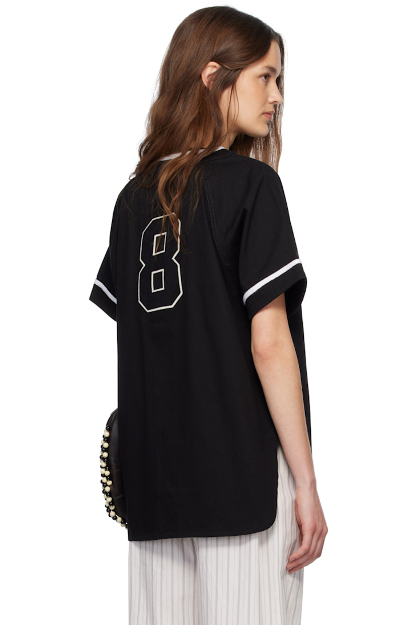 Cotton twill shirt.

· Webbing trim at V-neck and cuffs
· Button closure
· Logo embroidered at chest
· Felted text appliqué at front and back
· Shirttail hem
· Raglan sleeves

This item is part of a limited run of 136.

Supplier color: Black