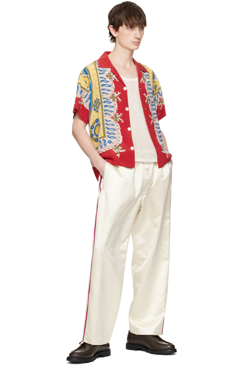 Polyester satin pyjama pants.

· Drawstring at elasticized waistband
· Three-pocket styling
· Exposed button fly
· Striped trim at outseams

This item is part of a limited run of 63.

Supplier color: Cream