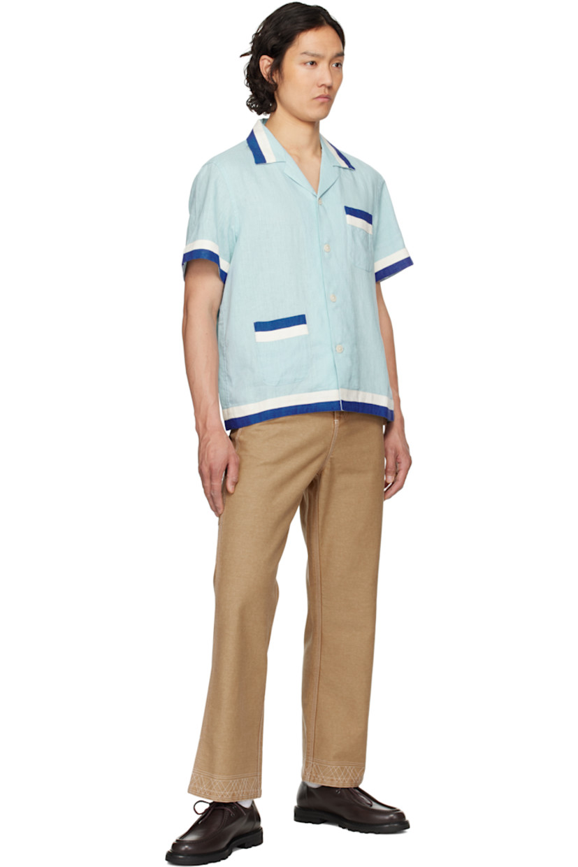 Lightweight plain-woven linen shirt. Striped trim throughout. 

· Open spread collar 
· Button closure 
· Patch pockets at front 

This item is part of a limited run of 235. 

Supplier color: White blue