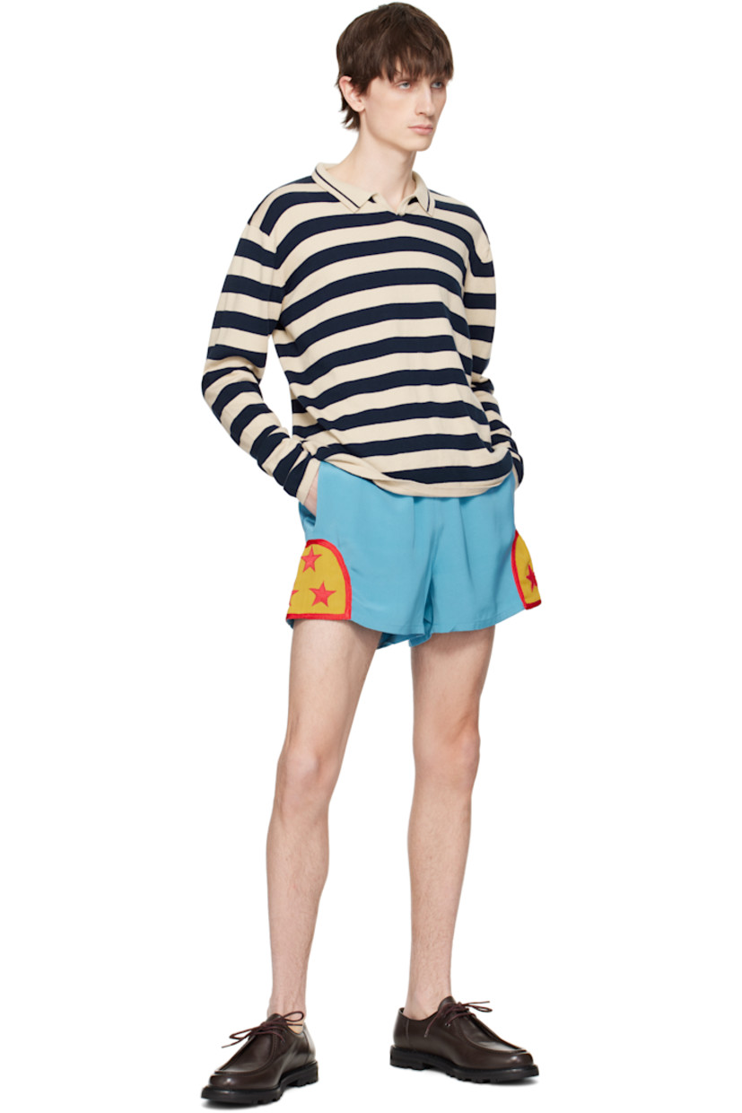 Plain-woven silk shorts.

· Concealed drawstring at striped elasticized waistband
· Three-pocket styling
· Graphic appliqués at cuffs
· Logo embroidered at back pocket

This item is part of a limited run of 82.

Supplier color: Blue