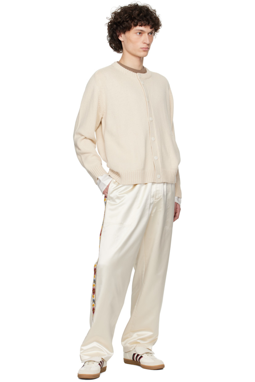 Knit pima cotton- and merino wool-blend cardigan. 

· Rib-knit round neck, hem, and cuffs 
· Button closure 
· Rib-knit trim at seam pockets 
· Raglan sleeves 
· Logo embroidered at back hem 
· Locker loop at interior collar 
· Mother-of-pearl hardware

This item is part of a limited run of 51.

Supplier color: Ivory