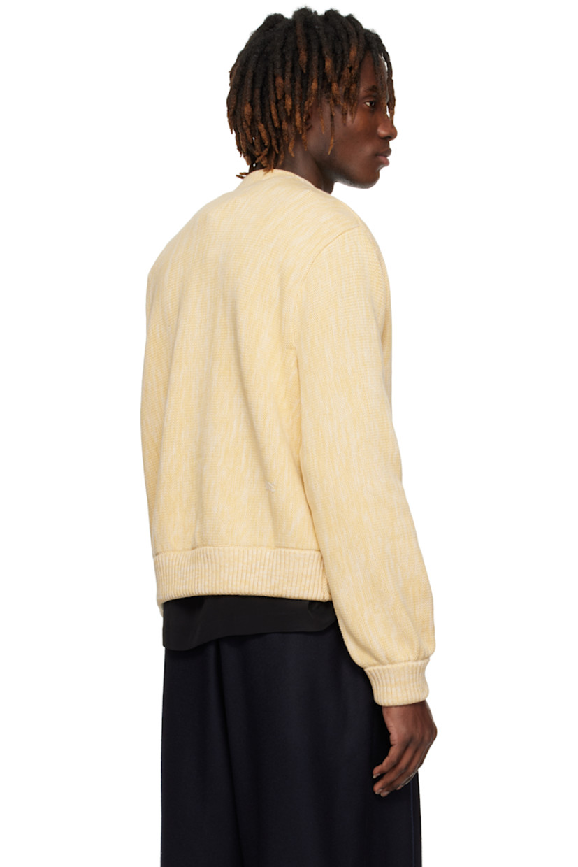 Knit cotton cardigan.

· Y-neck
· Double-breasted button closure
· Partially rib-knit hem 
· Button vent at side seams
· Rib-knit cuffs
· Hand-embroidered logo at back

This item is part of a limited run of 121.

Supplier color: Marled ivory