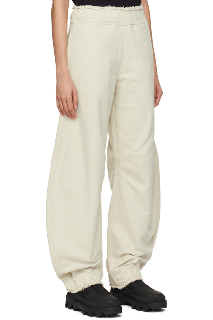 French terry sweatpants.

· Concealed drawstring at elasticized waistband
· Raw edge at waistband and cuffs
· Three-pocket styling
· Embroidered logo patch with O-ring at front
· Darts at inseams
· Elasticized cuffs

Part of the Moncler Genius x Willow Smith collaboration.

Supplier color: Beige