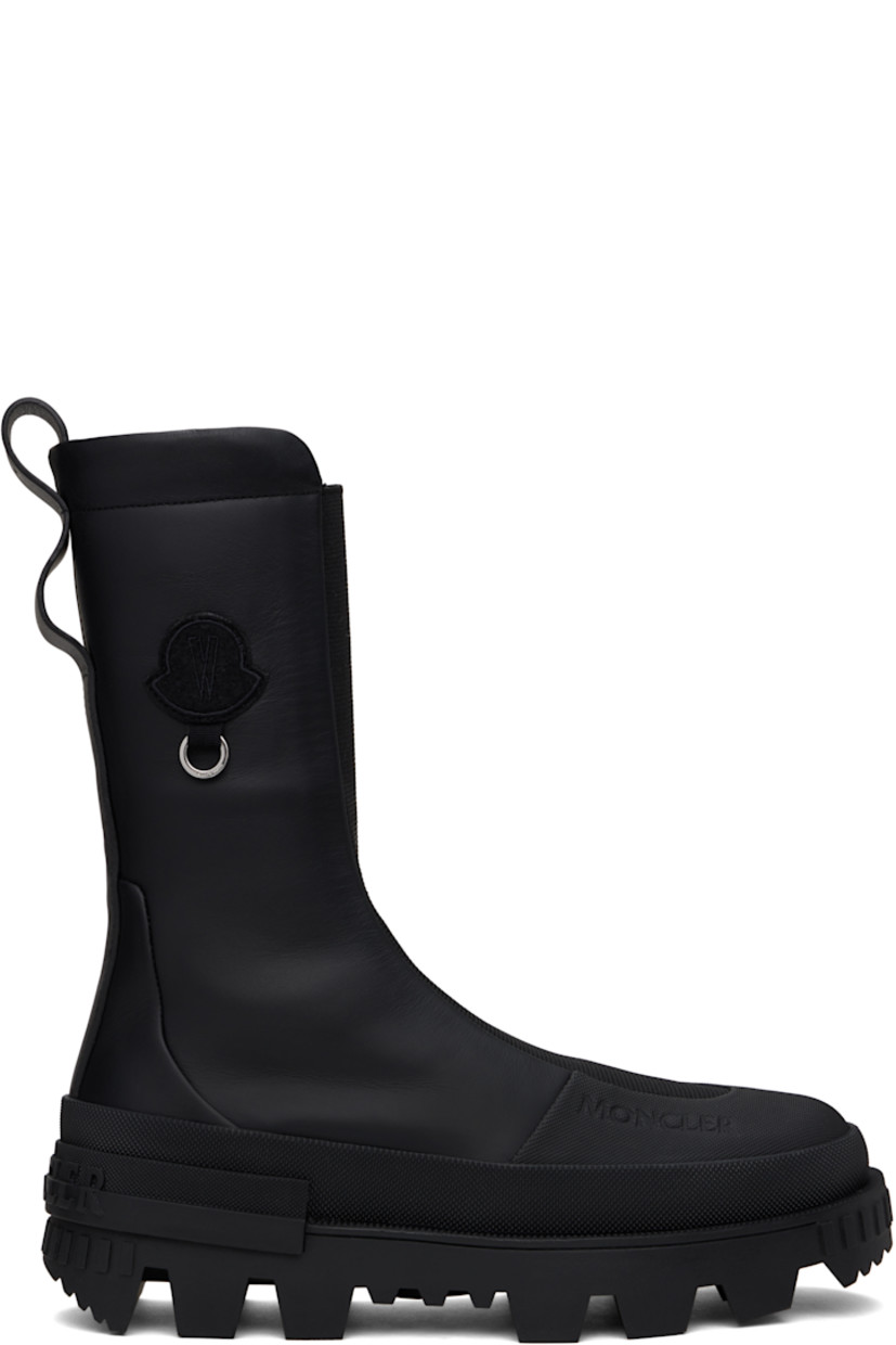 Ankle-high buffed leather boots in black.

· Logo embossed at rubber toe cap
· Elasticized gusset at vamp
· Embroidered logo patch with O-ring at outer side
· Pull-loops at heel collar 
· Logo embossed at heel
· Jersey lining
· Treaded rubber sole

Part of the Moncler Genius x Willow Smith collaboration.

Supplier color: Black