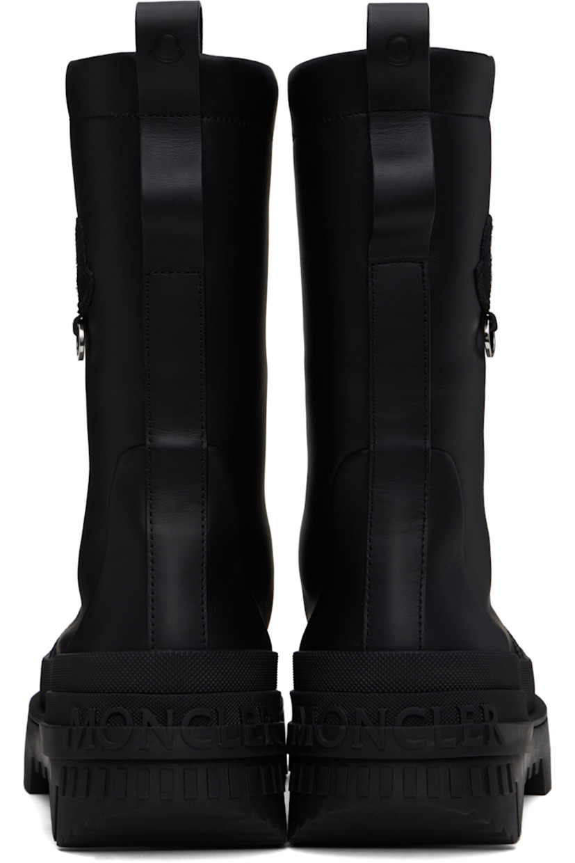 Ankle-high buffed leather boots in black.

· Logo embossed at rubber toe cap
· Elasticized gusset at vamp
· Embroidered logo patch with O-ring at outer side
· Pull-loops at heel collar 
· Logo embossed at heel
· Jersey lining
· Treaded rubber sole

Part of the Moncler Genius x Willow Smith collaboration.

Supplier color: Black