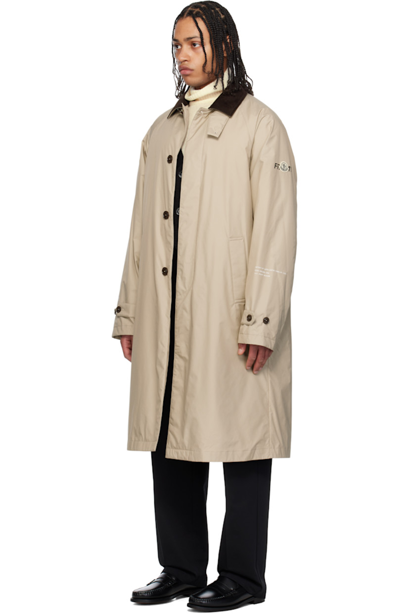 Down-filled 2L GORE-TEX INFINIUM™ nylon ripstop coat. 

· DIST-certified down
· Button tab at cotton corduroy spread collar
· Concealed button closure
· Welt pockets
· Raglan sleeves
· Felted logo patch and printed logo at sleeve
· Text printed at cuffs
· Adjustable buttoned tab at cuffs
· Central vent at back hem 
· Full nylon laqué lining

Part of the Moncler Genius x FRGMT by Hiroshi Fujiwara collaboration.

Supplier color: Sand beige

Fill: 90% goose down, 10% feather.