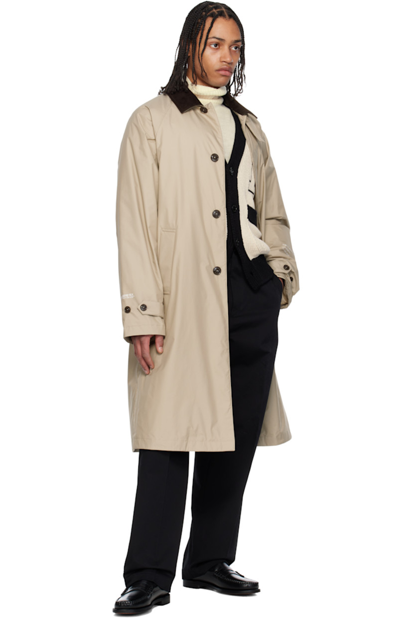 Down-filled 2L GORE-TEX INFINIUM™ nylon ripstop coat. 

· DIST-certified down
· Button tab at cotton corduroy spread collar
· Concealed button closure
· Welt pockets
· Raglan sleeves
· Felted logo patch and printed logo at sleeve
· Text printed at cuffs
· Adjustable buttoned tab at cuffs
· Central vent at back hem 
· Full nylon laqué lining

Part of the Moncler Genius x FRGMT by Hiroshi Fujiwara collaboration.

Supplier color: Sand beige

Fill: 90% goose down, 10% feather.