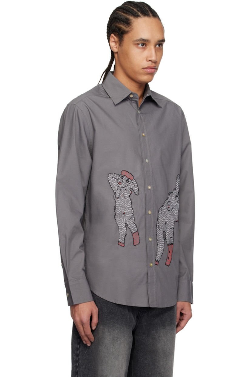 Cotton poplin shirt.

· Spread collar
· Button closure
· Hand-embroidered graphics at front
· Shirttail hem
· Saddle shoulders
· Pleated single-button barrel cuffs
· Twin pleats at back yoke
· Mother-of-pearl hardware

Supplier color: Gray