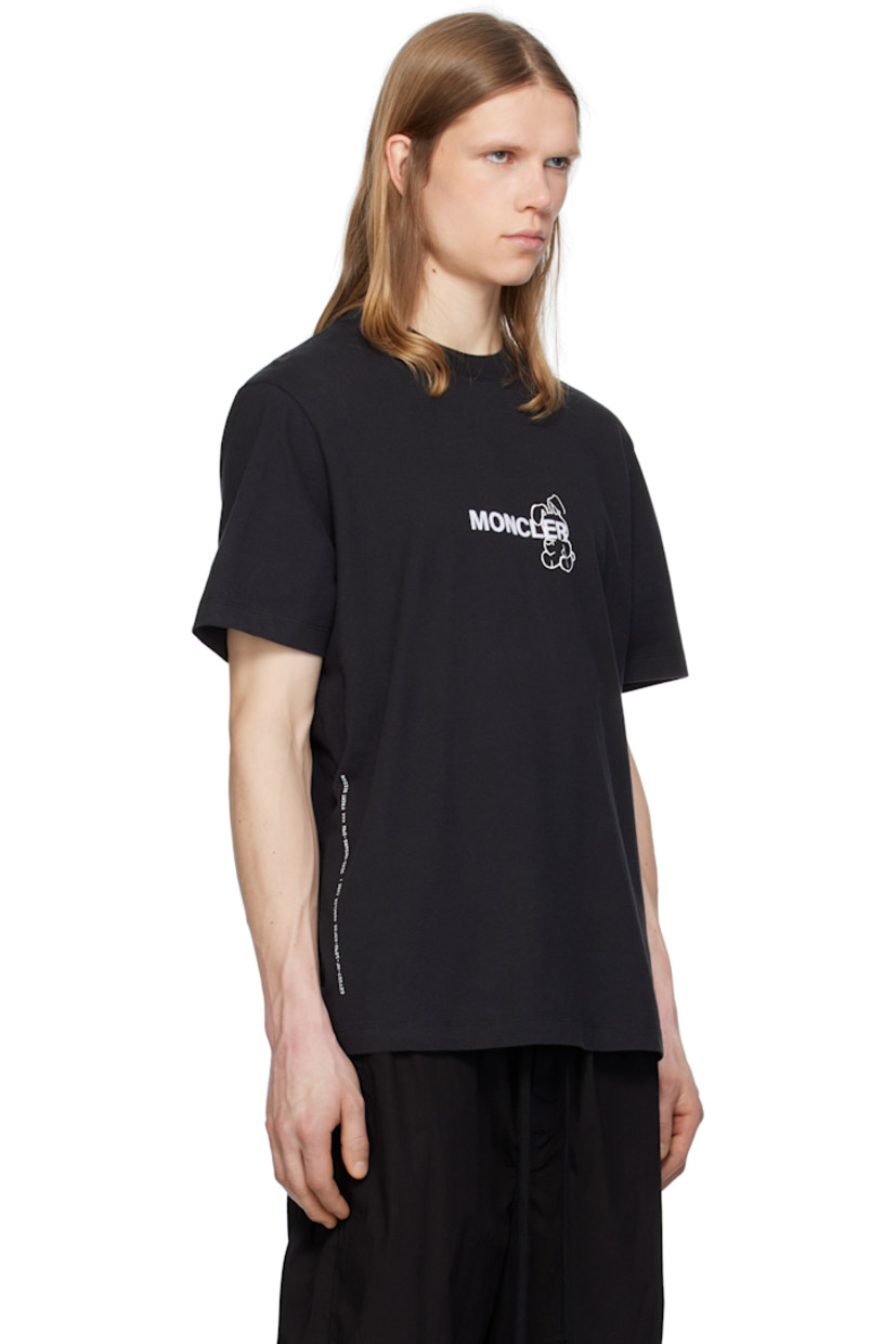 Cotton jersey T-shirt. 

· Rib-knit crewneck
· Graphic, text, and logo printed at front
· Felted logo at front and back
· Felted logo patch at sleeve
· Logo and graphic printed at back 
 
Part of the Moncler Genius x FRGMT by Hiroshi Fujiwara collaboration.

Supplier color: Black