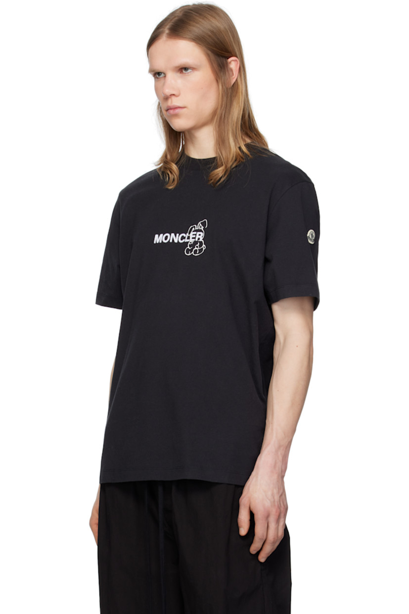 Cotton jersey T-shirt. 

· Rib-knit crewneck
· Graphic, text, and logo printed at front
· Felted logo at front and back
· Felted logo patch at sleeve
· Logo and graphic printed at back 
 
Part of the Moncler Genius x FRGMT by Hiroshi Fujiwara collaboration.

Supplier color: Black