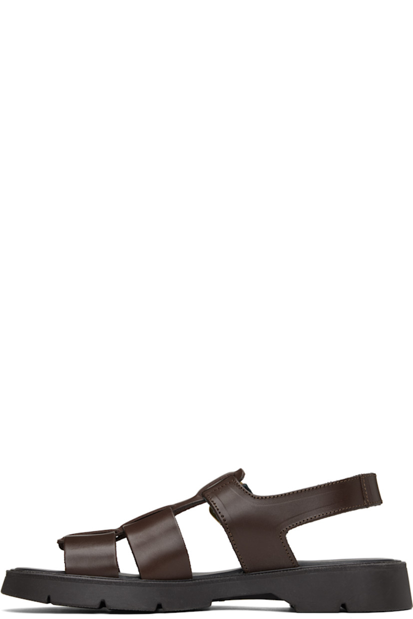 Vegetable-tanned buffed leather sandals in brown.

· LWG-certified and chrome-free leather
· Open toe
· Partially-elasticized pin-buckle ankle strap
· Slingback strap
· Logo embossed at padded footbed
· Grained leather and suede lining
· Serrated detailing at welt
· Treaded rubber sole
· Antiqued brass-tone hardware

Supplier color: Brown