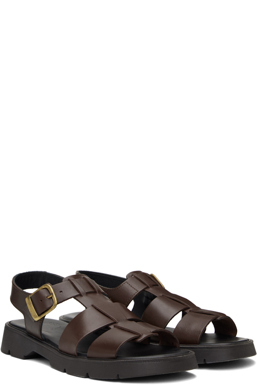 Vegetable-tanned buffed leather sandals in brown.

· LWG-certified and chrome-free leather
· Open toe
· Partially-elasticized pin-buckle ankle strap
· Slingback strap
· Logo embossed at padded footbed
· Grained leather and suede lining
· Serrated detailing at welt
· Treaded rubber sole
· Antiqued brass-tone hardware

Supplier color: Brown