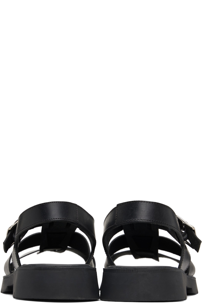 Vegetable-tanned buffed leather sandals in black.

· LWG-certified and chrome-free leather
· Open toe
· Partially-elasticized pin-buckle ankle strap
· Slingback strap
· Logo embossed at padded footbed
· Grained leather and suede lining
· Serrated detailing at welt
· Treaded rubber sole
· Silver-tone hardware

Supplier color: Black