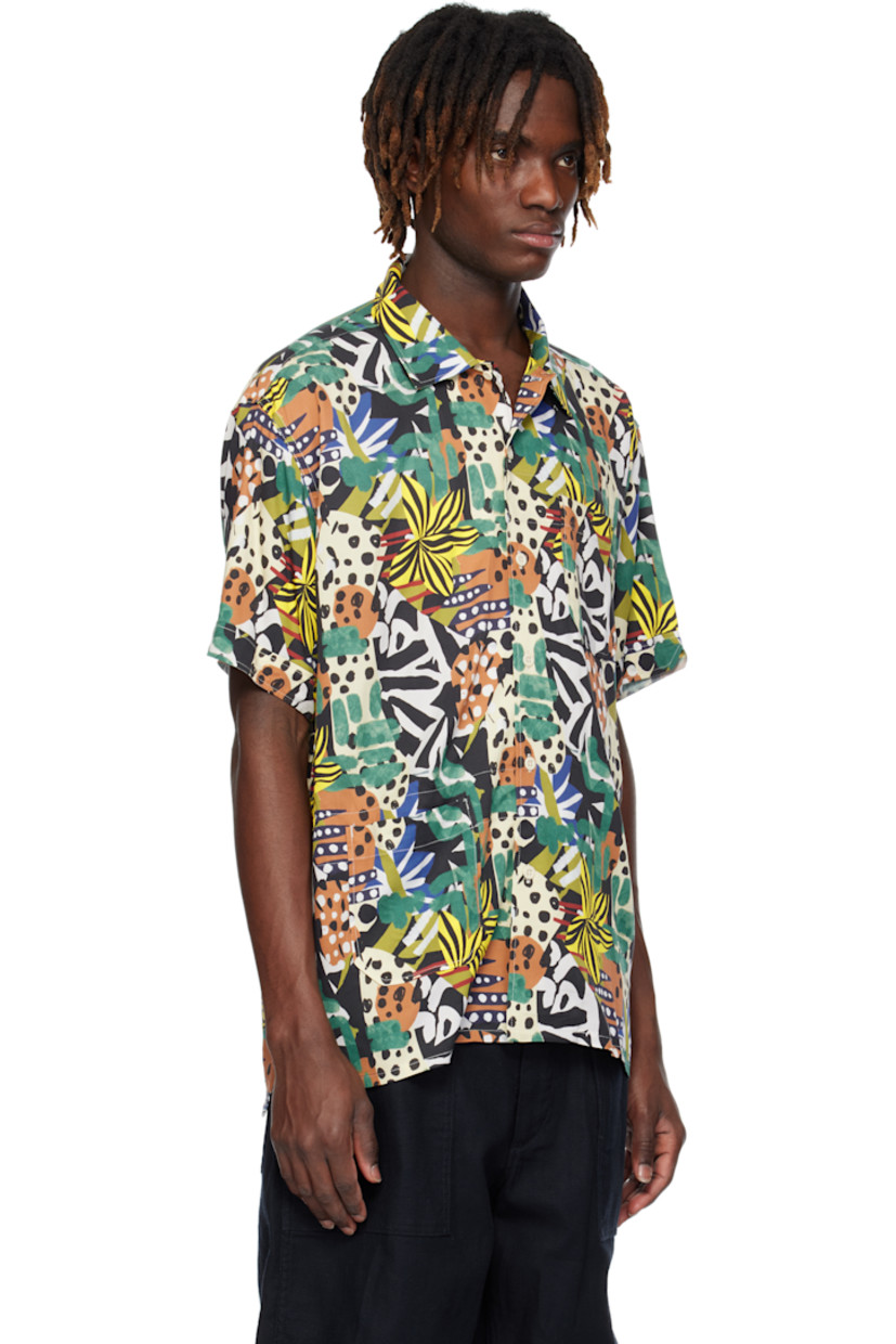 Rayon twill shirt. Graphic pattern printed throughout. 

· Open spread collar
· Button closure
· Patch pockets at front 
· Tennis-tail hem
· Vent at cuffs
· Twin pleats at back yoke 
· Contrast stitching in white

Supplier color: Multi color African print