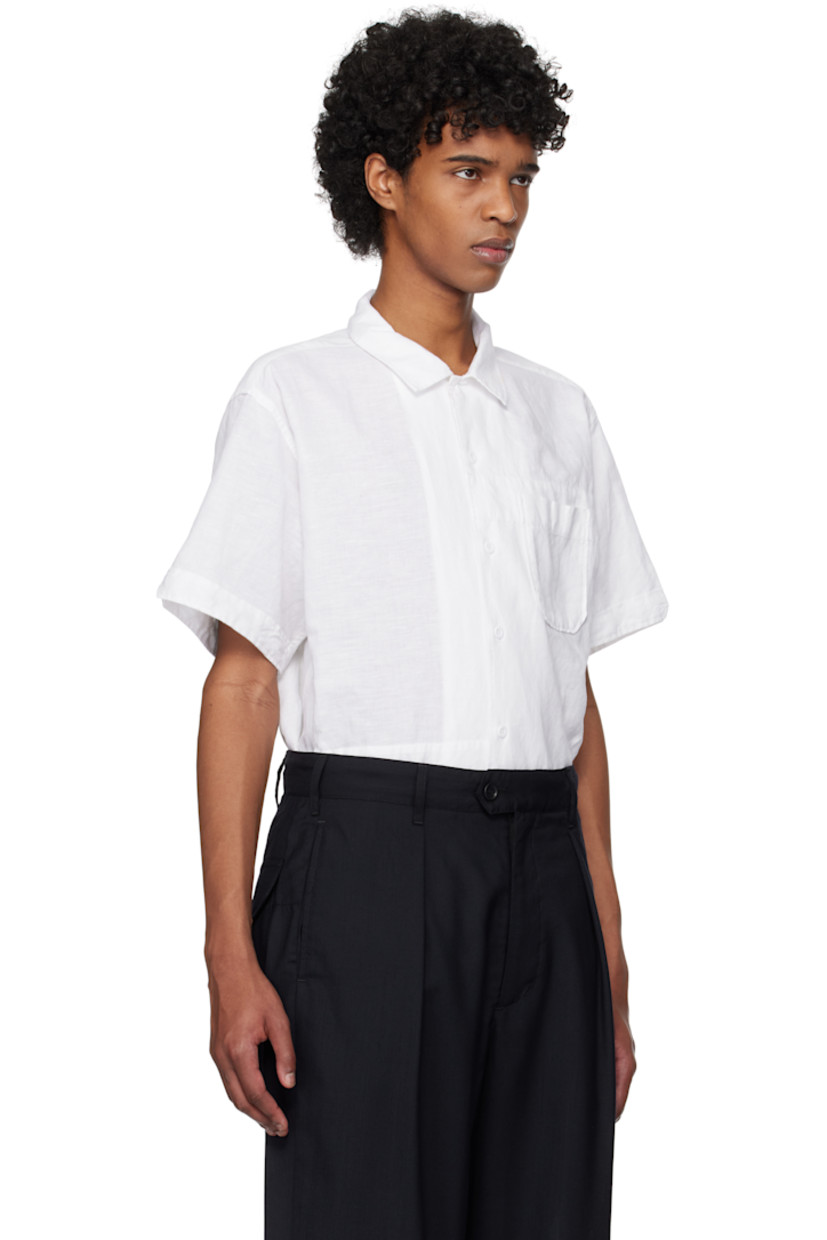 Linen- and cotton-blend muslin shirt.

· Spread collar
· Button closure
· Patch pocket
· Vented side seams
· Twin pleats at back yoke

Supplier color: White