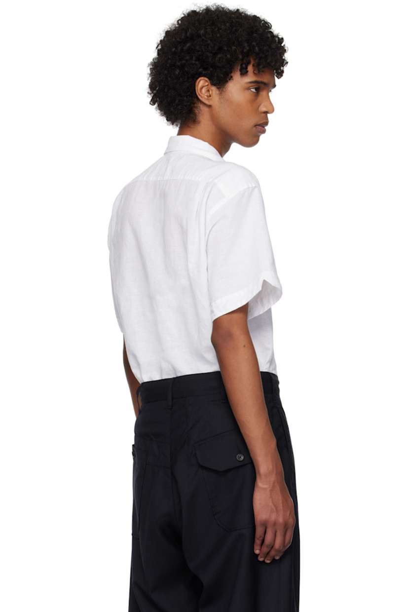 Linen- and cotton-blend muslin shirt.

· Spread collar
· Button closure
· Patch pocket
· Vented side seams
· Twin pleats at back yoke

Supplier color: White