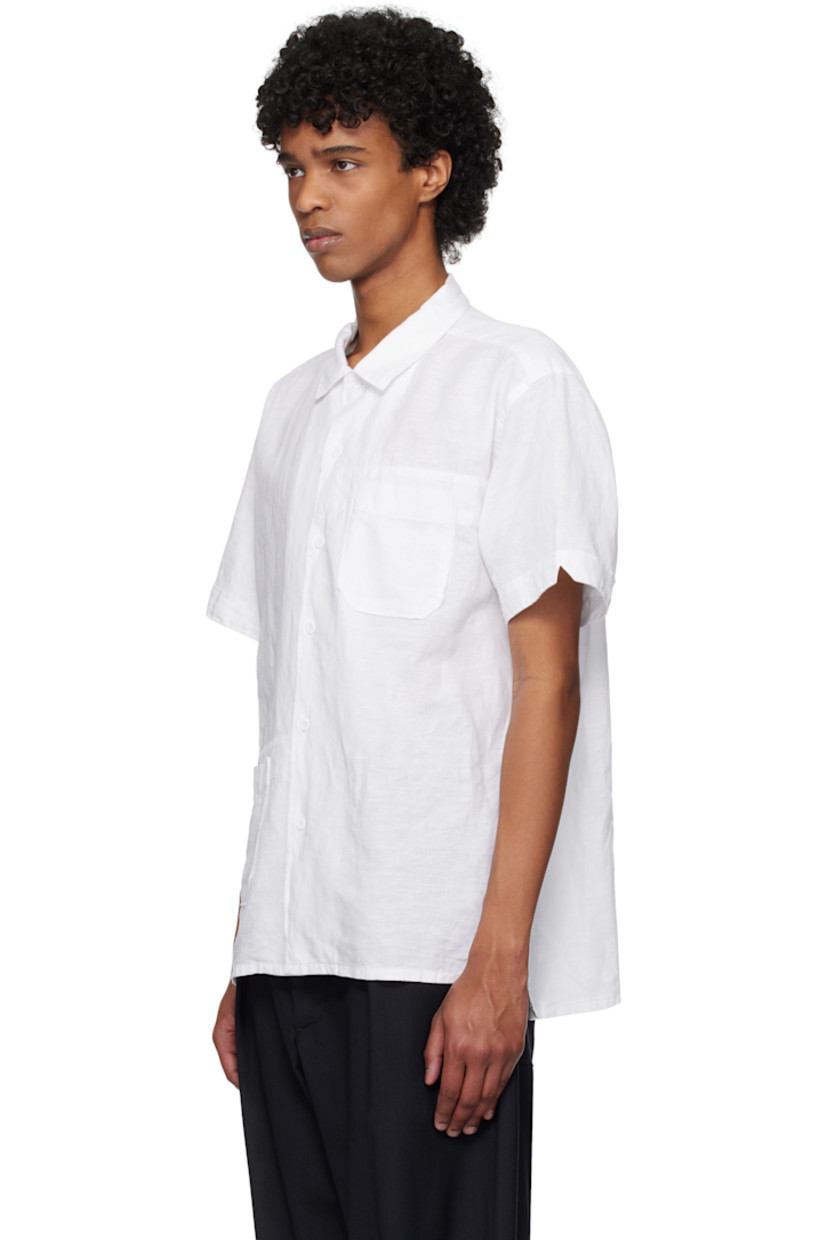 Linen- and cotton-blend muslin shirt.

· Spread collar
· Button closure
· Patch pocket
· Vented side seams
· Twin pleats at back yoke

Supplier color: White