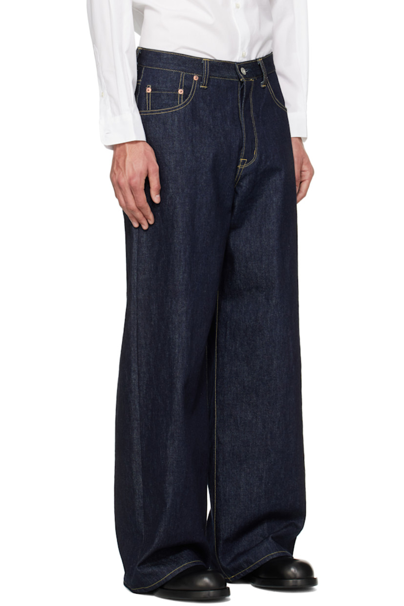 Non-stretch 13 oz denim jeans.

· Belt loops
· Five-pocket styling
· Button fly
· Logo patch at back pocket
· Zip fastening at back legs
· Contrast stitching in tan

Supplier color: Indigo