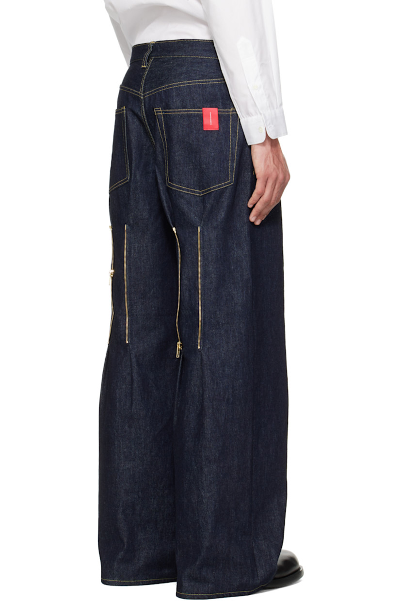 Non-stretch 13 oz denim jeans.

· Belt loops
· Five-pocket styling
· Button fly
· Logo patch at back pocket
· Zip fastening at back legs
· Contrast stitching in tan

Supplier color: Indigo