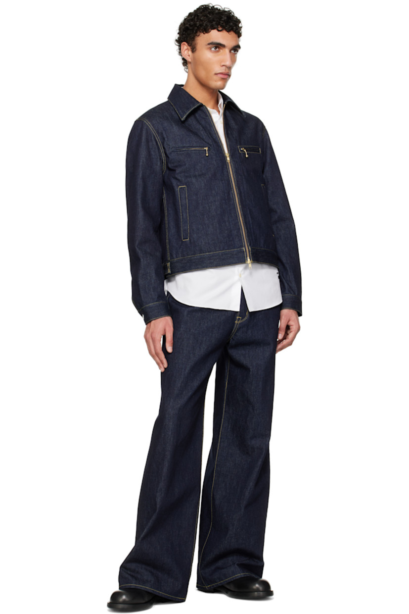 Non-stretch 13 oz denim jeans.

· Belt loops
· Five-pocket styling
· Button fly
· Logo patch at back pocket
· Zip fastening at back legs
· Contrast stitching in tan

Supplier color: Indigo