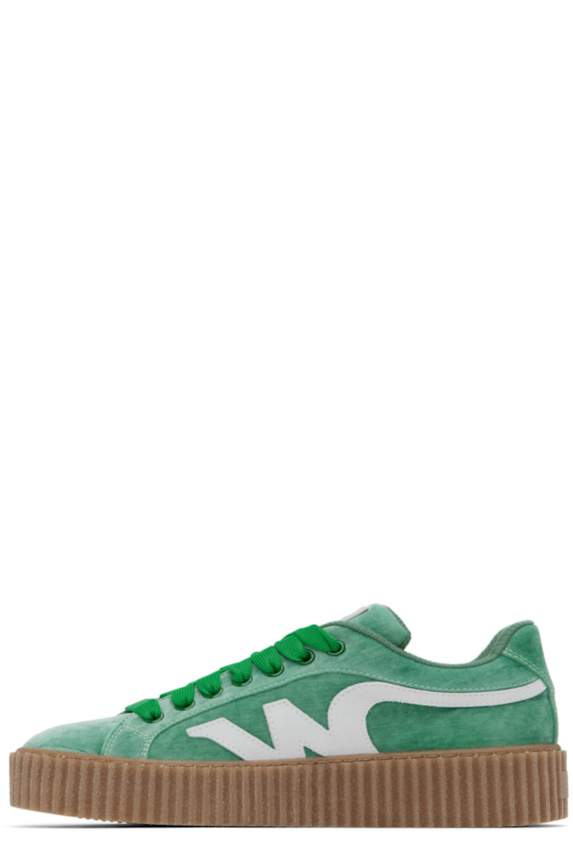 Low-top velvet sneakers in green.

· Lace-up closure
· Rubberized logo patch at padded tongue
· Padded collar
· Suede logo appliqué at sides
· Jersey lining
· Logo embossed at textured rubber platform midsole
· Treaded rubber sole
· Platform: H1.5"

Supplier color: Emerald