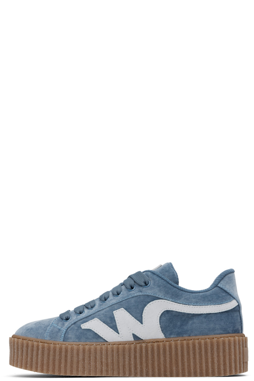Low-top velvet sneakers in blue.

· Lace-up closure
· Rubberized logo patch at padded tongue
· Padded collar
· Suede logo appliqué at sides
· Jersey lining
· Logo embossed at textured rubber platform midsole
· Treaded rubber sole
· Platform: H1.5"

Supplier color: Light blue