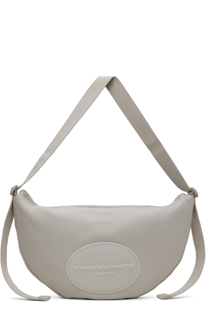 Polyurethane-coated nylon canvas shoulder bag in gray.

· Adjustable crossbody strap
· Rubberized logo patch at face
· Zip closure
· Zip pocket at interior
· Twill lining
· H11" x W17.5" x D2"

Supplier color: Oyster