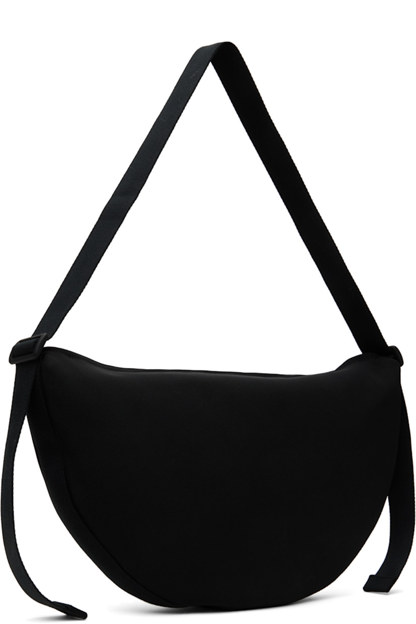 Nylon canvas messenger bag in black. 

· Adjustable webbing crossbody strap
· Rubberized logo patch at face
· Zip closure
· Zip pocket at interior 
· Full twill lining
· H11" x W18.5" x D2"

Supplier color: Black