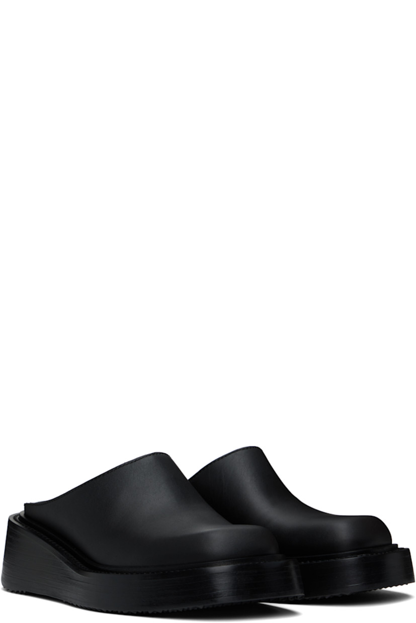 Buffed leather slip-on loafers in black.

· Square toe
· Logo plaque at heel
· Buffed leather lining
· Logo printed at padded leather footbed
· Stacked leather platform midsole
· Treaded rubber sole
· Platform: H2"

Supplier color: Black