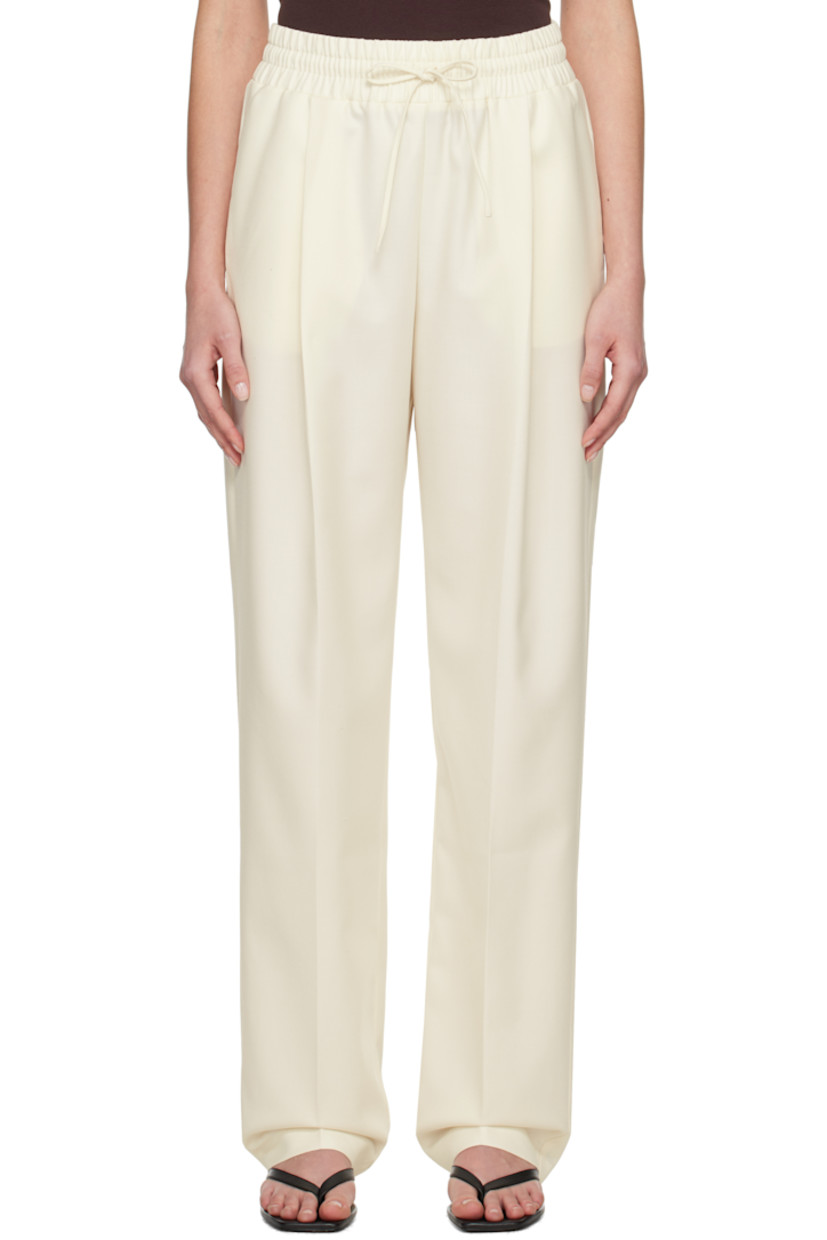 Wool-blend twill trousers.

· Drawstring at elasticized waistband
· Three-pocket styling
· Pleats at front
· Creased legs

Supplier color: White