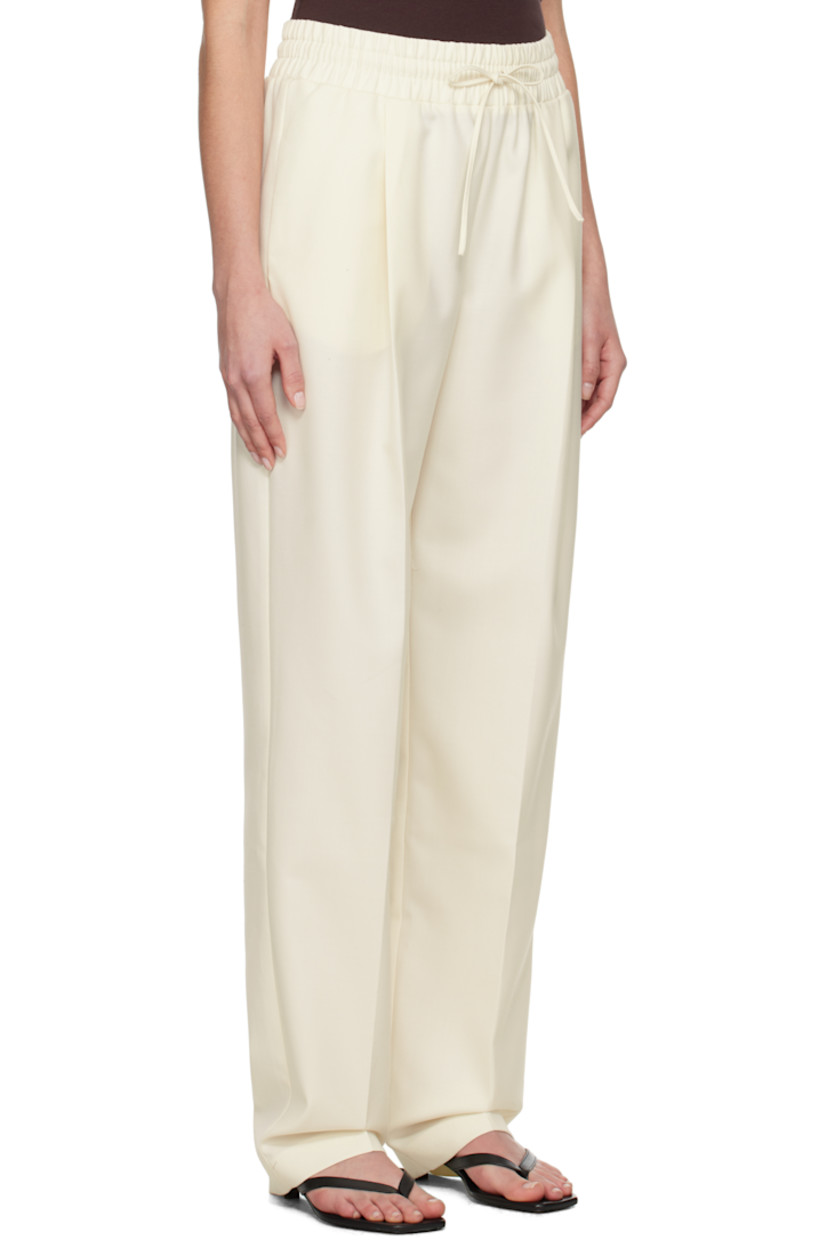 Wool-blend twill trousers.

· Drawstring at elasticized waistband
· Three-pocket styling
· Pleats at front
· Creased legs

Supplier color: White