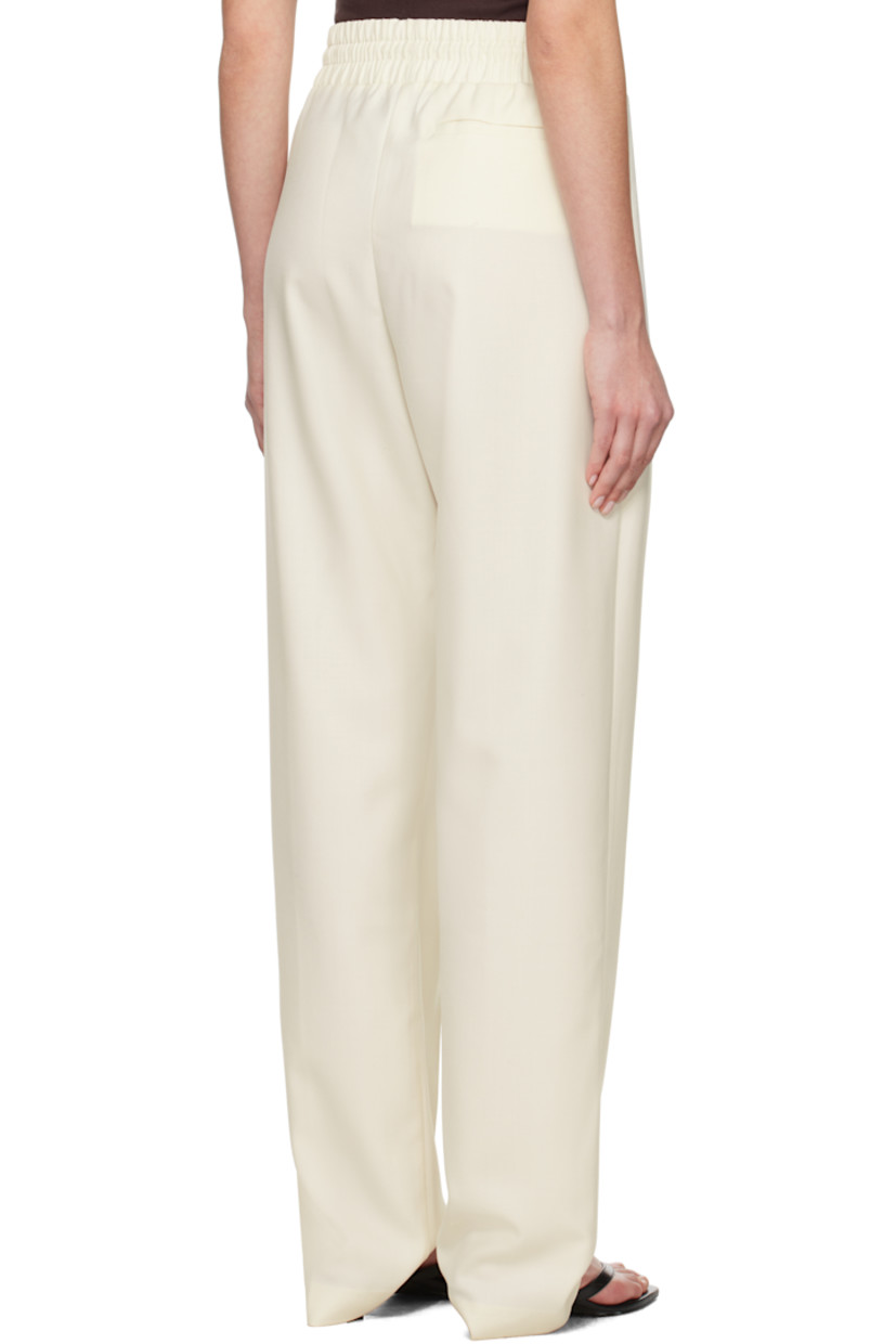 Wool-blend twill trousers.

· Drawstring at elasticized waistband
· Three-pocket styling
· Pleats at front
· Creased legs

Supplier color: White