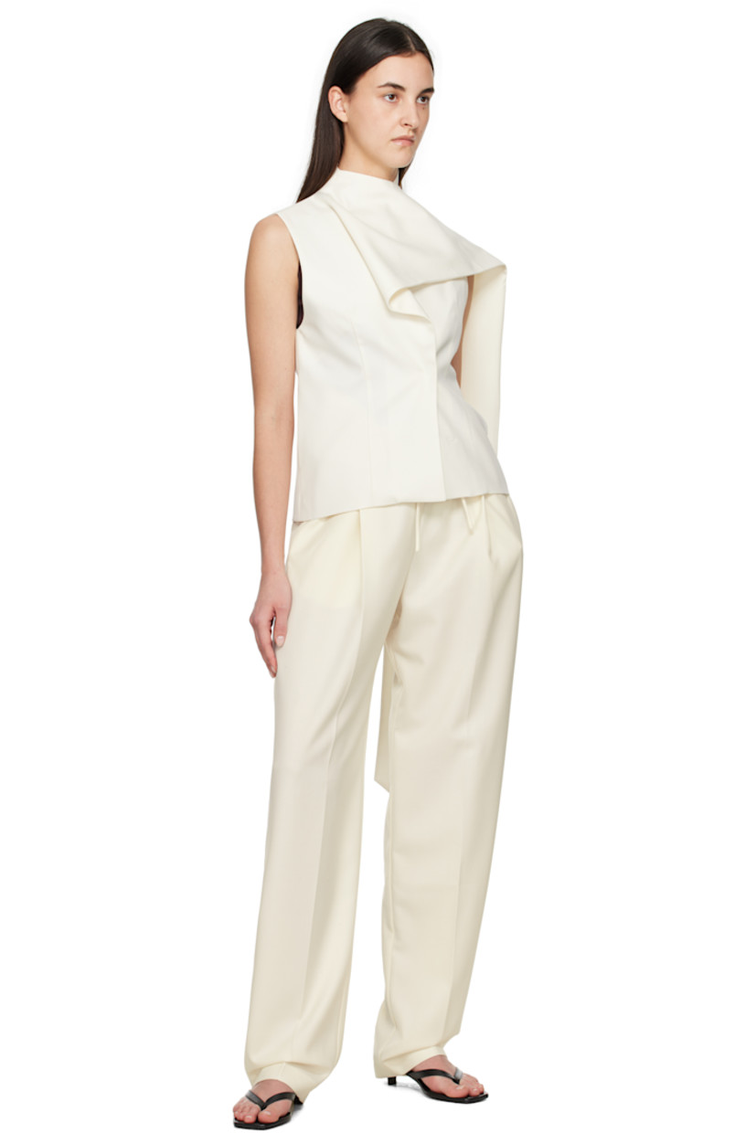 Wool-blend twill trousers.

· Drawstring at elasticized waistband
· Three-pocket styling
· Pleats at front
· Creased legs

Supplier color: White