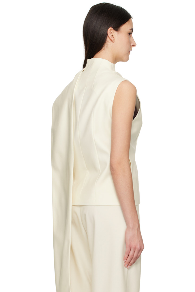 Wool-blend twill top. 

· Wrap construction
· Draped extended trim at funnel neck
· Concealed button closure
· Darts at front and back
· Seam pockets
· Partially lined 

Supplier color: White