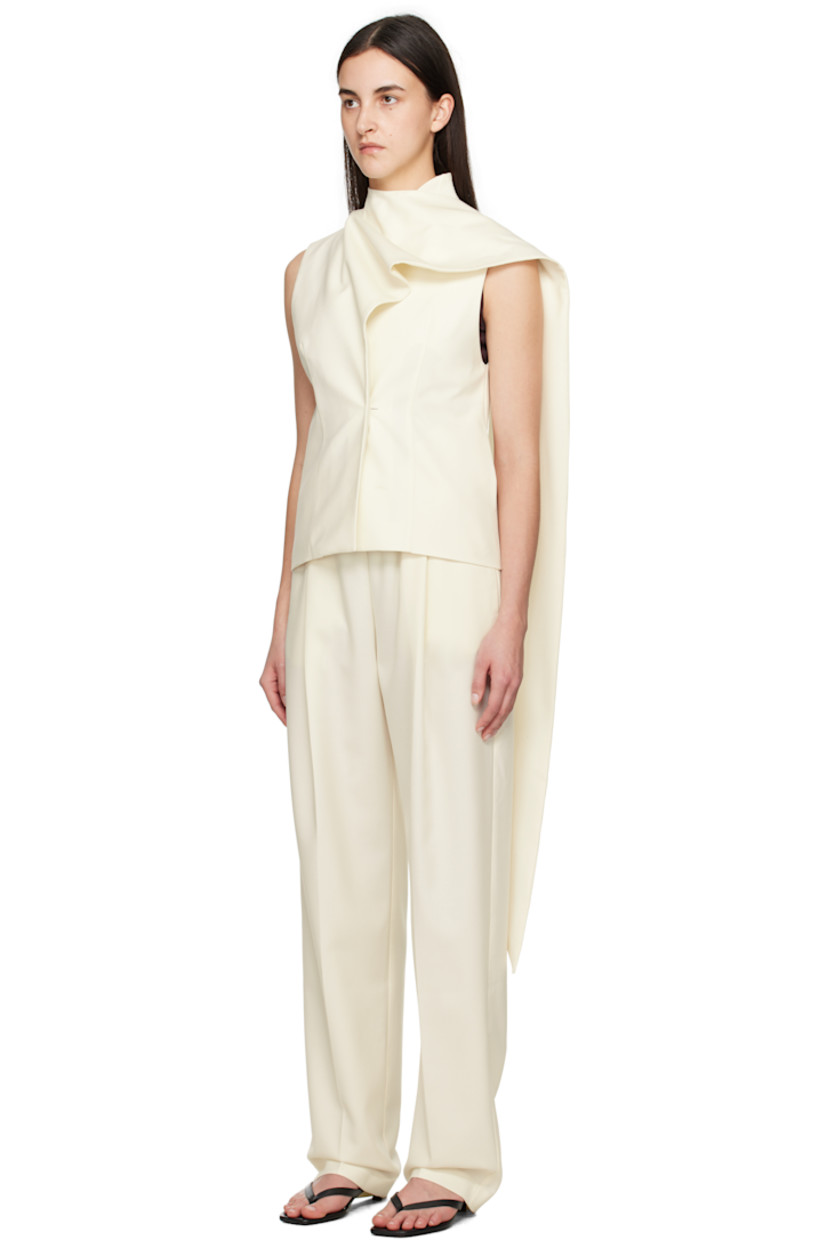 Wool-blend twill top. 

· Wrap construction
· Draped extended trim at funnel neck
· Concealed button closure
· Darts at front and back
· Seam pockets
· Partially lined 

Supplier color: White