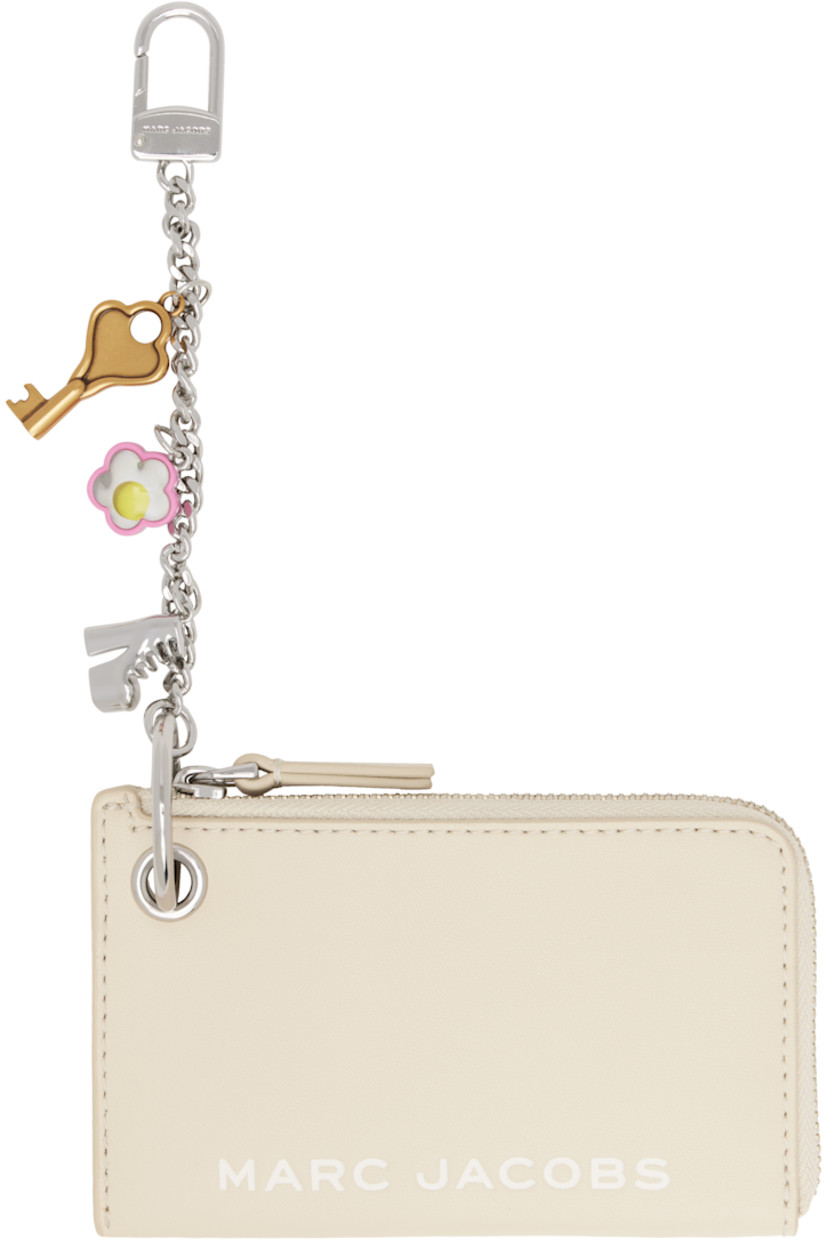 Grained leather coin pouch in off-white.

· Logo embossed at face
· Lanyard clasp at side
· Detachable curb chain with graphic charms
· Zip closure
· Twill lining
· H3.25" x W5" x D0.75"

Supplier color: Cloud white