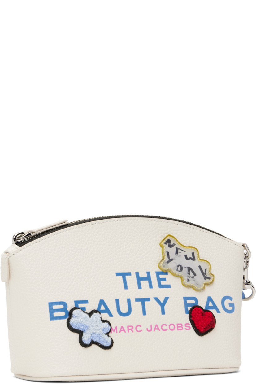 Pebbled leather cosmetic pouch in white.

· Detachable wristlet strap
· Text and logo printed at face
· Chenille and graphic patches 
· Logo patch at back face
· Zip closure
· Twill lining
· H5.25" x W8" x D3"

Supplier color: White/Multi