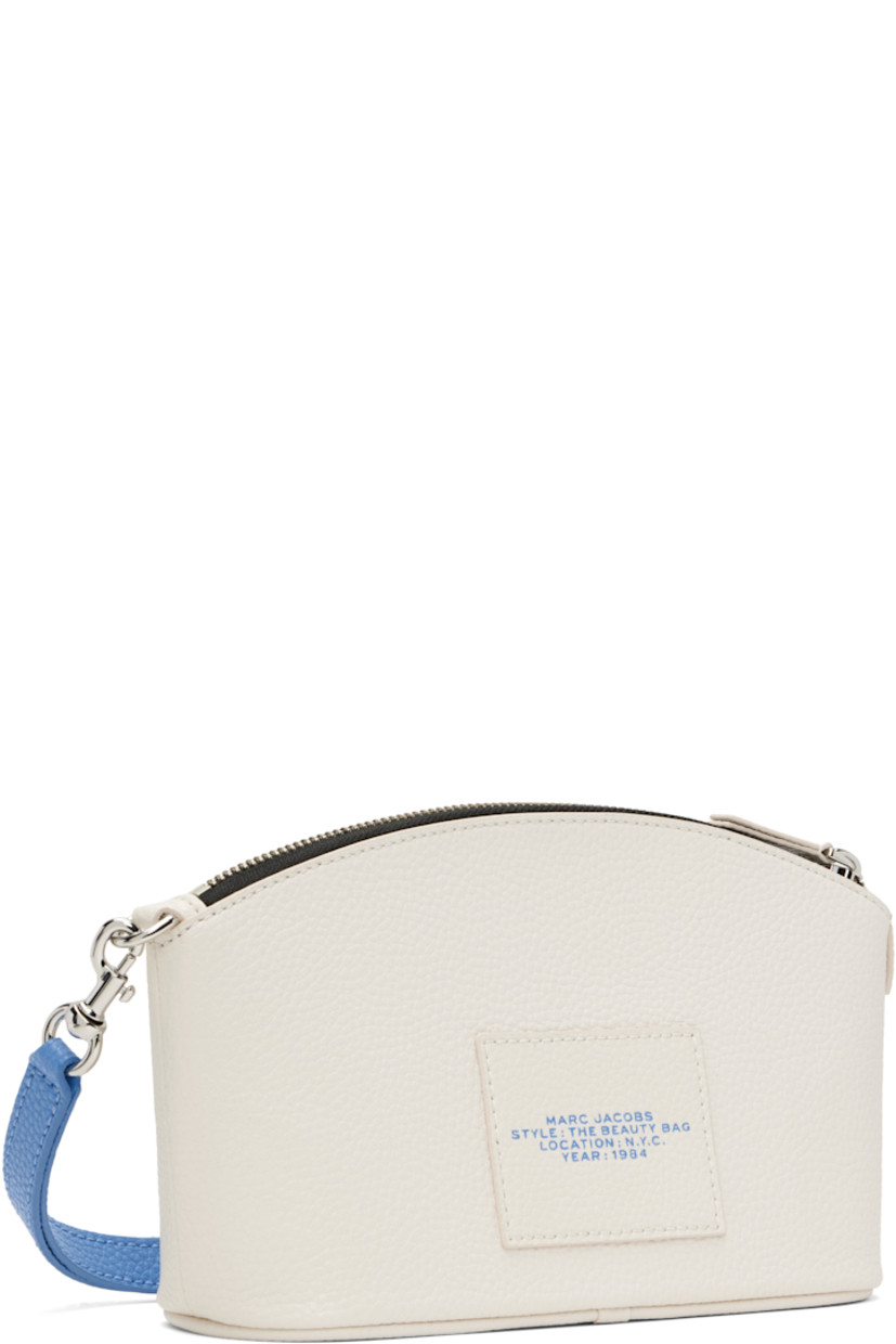 Pebbled leather cosmetic pouch in white.

· Detachable wristlet strap
· Text and logo printed at face
· Chenille and graphic patches 
· Logo patch at back face
· Zip closure
· Twill lining
· H5.25" x W8" x D3"

Supplier color: White/Multi