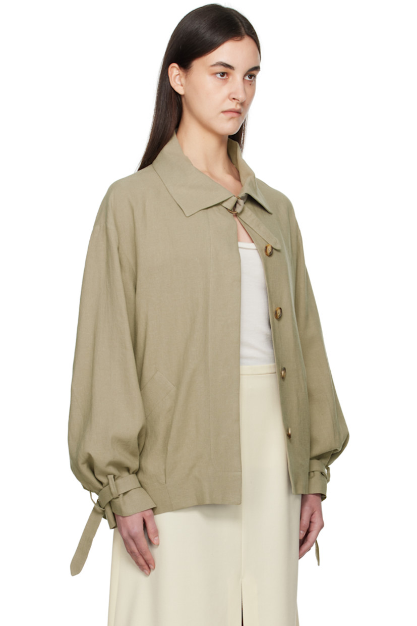 Plain-woven linen jacket. 

· Detachable cinch fastening at spread collar
· Concealed button closure
· Belt loops and detachable pin-buckle belt
· Welt pockets
· Tucks at front hem
· Adjustable cinch tab at cuffs
· Welt pockets at interior
· Full silk satin lining

Supplier color: Sage