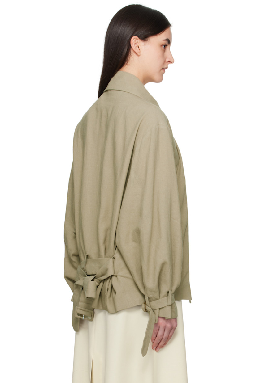 Plain-woven linen jacket. 

· Detachable cinch fastening at spread collar
· Concealed button closure
· Belt loops and detachable pin-buckle belt
· Welt pockets
· Tucks at front hem
· Adjustable cinch tab at cuffs
· Welt pockets at interior
· Full silk satin lining

Supplier color: Sage