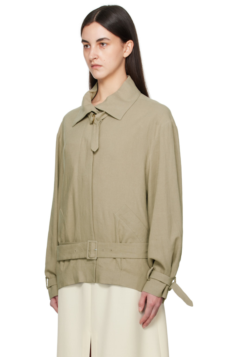 Plain-woven linen jacket. 

· Detachable cinch fastening at spread collar
· Concealed button closure
· Belt loops and detachable pin-buckle belt
· Welt pockets
· Tucks at front hem
· Adjustable cinch tab at cuffs
· Welt pockets at interior
· Full silk satin lining

Supplier color: Sage