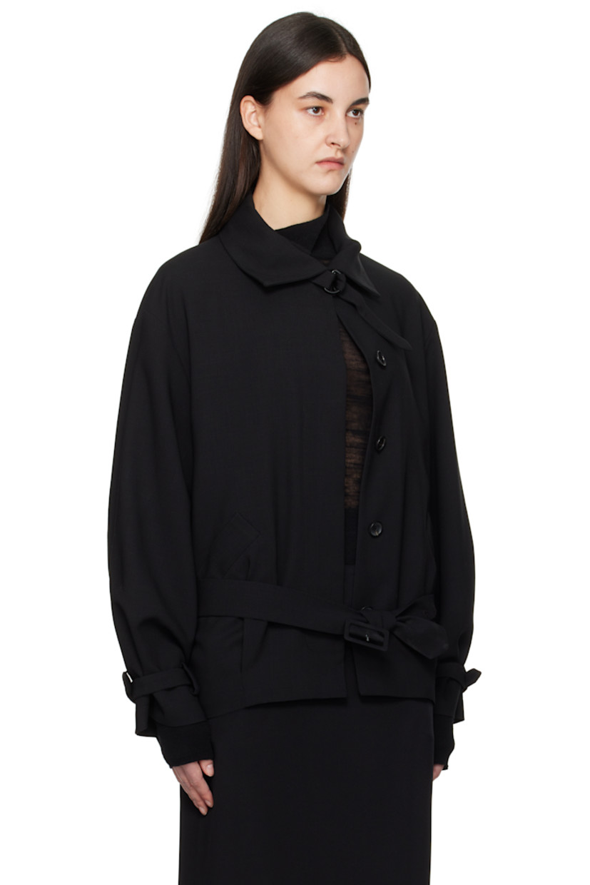 Virgin wool twill jacket. 

· Detachable cinch fastening at spread collar
· Concealed button closure
· Belt loops and detachable pin-buckle belt
· Welt pockets
· Tucks at front hem
· Adjustable cinch tab at cuffs
· Welt pockets at interior
· Full silk satin lining

Supplier color: Black