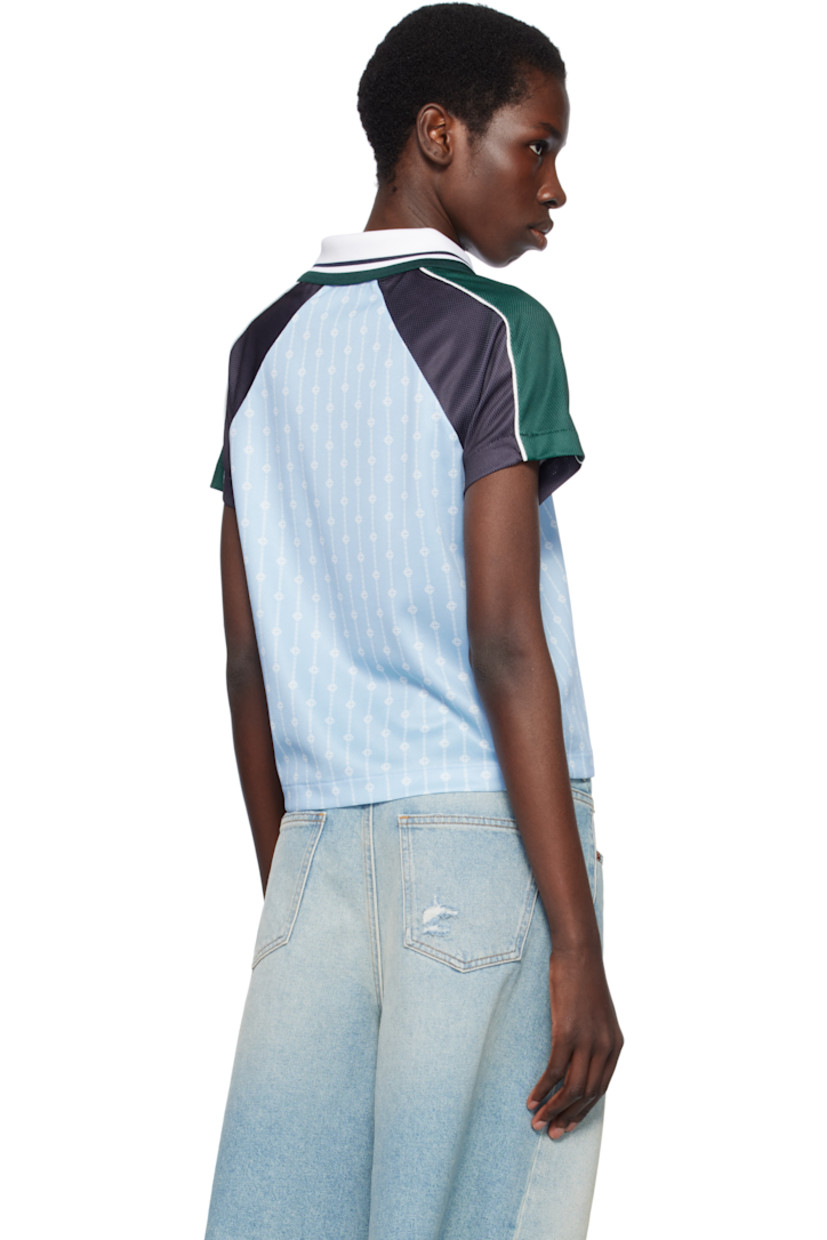 Polyester mesh T-shirt. Logo graphic pinstripes printed throughout.

· Striped rib-knit spread collar at V-neck
· Embroidered logo patch at chest
· Logo printed at front 
· Piping at raglan sleeves

Supplier color: Blue