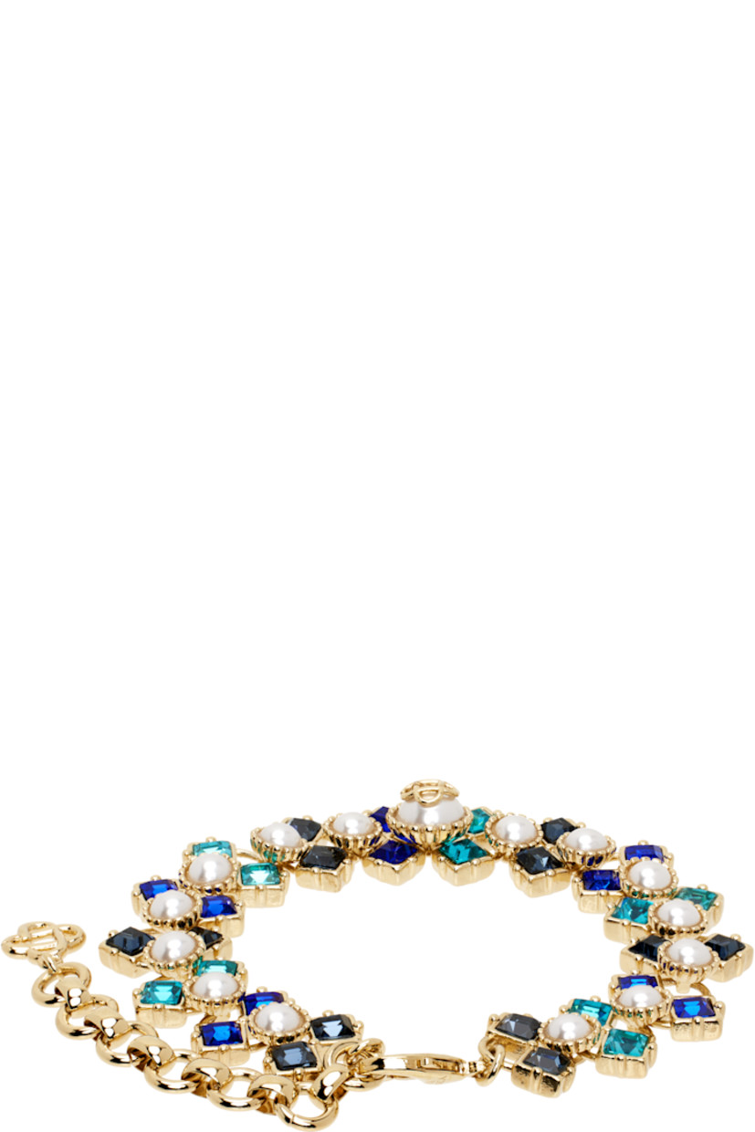 Modified cup chain bracelet in gold-tone brass.

· Faux-pearls and blue crystals at length
· Logo charm at adjustable lobster-clasp fastening
· L8"

Supplier color: Gold/Blue