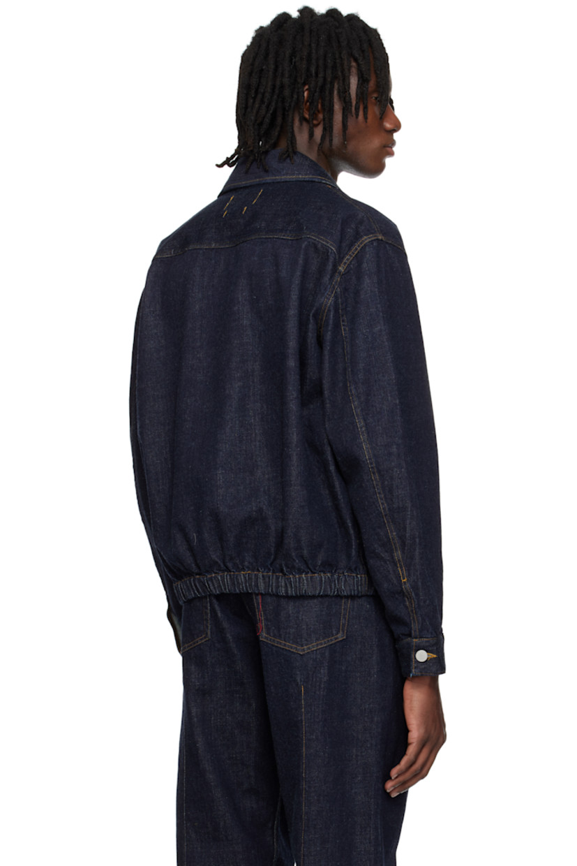 Non-stretch denim jacket. 

· Spread collar
· Two-way zip closure
· Welt pockets
· Elasticized hem
· Single-button barrel cuffs
· Logo-engraved silver-tone hardware
· Contrast stitching in tan

Supplier color: Indigo