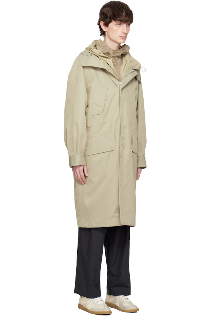 Water-repellent cotton- and polyester-blend twill coat. Includes detachable nylon taffeta liner.

· Bungee-style drawstring at hood
· Zip closure with press-stud placket
· Flap pockets
· Concealed bungee-style drawstring at waist
· Raglan sleeves
· Adjustable press-stud barrel cuffs 
· Welt pockets at interior 
· Full nylon satin lining
· Logo-engraved silver-tone hardware

Supplier color: Beige